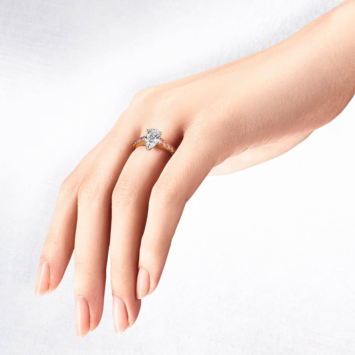 Hand wearing a round brilliant cut diamond ring